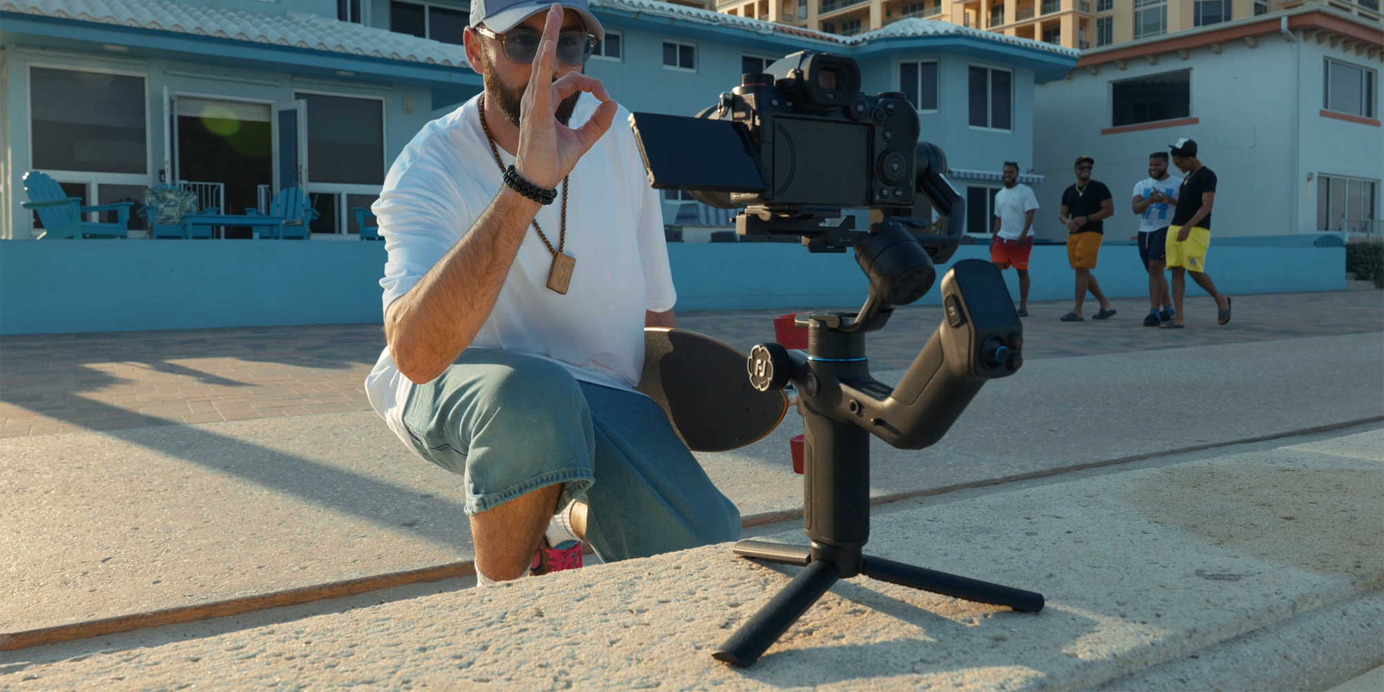 Gimbal ręczny FeiyuTech Scorp mini 3 Pro przed mężczyzną, który kontroluje urządzenie za pomocą gestu ok